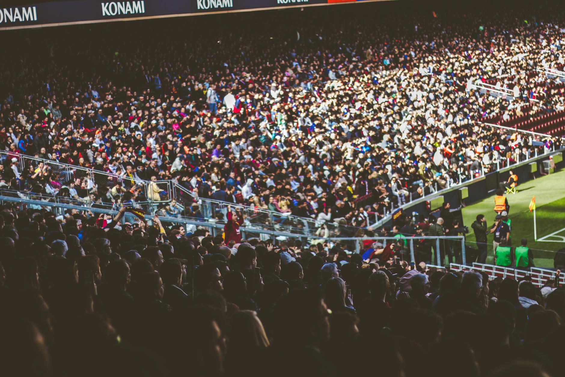 Liverpool Football Tourism: Anfield, Everton & Match Day Guide 4 Football fans creating an electric matchday atmosphere inside a packed stadium