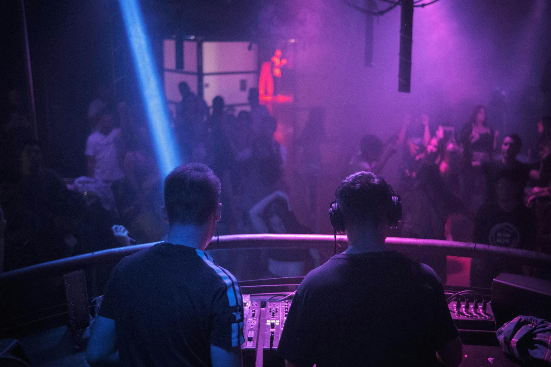 Liverpool Nightlife Guide: Bars, Clubs & Live Music 6 A packed nightclub dance floor in Liverpool with DJ decks and colourful lighting