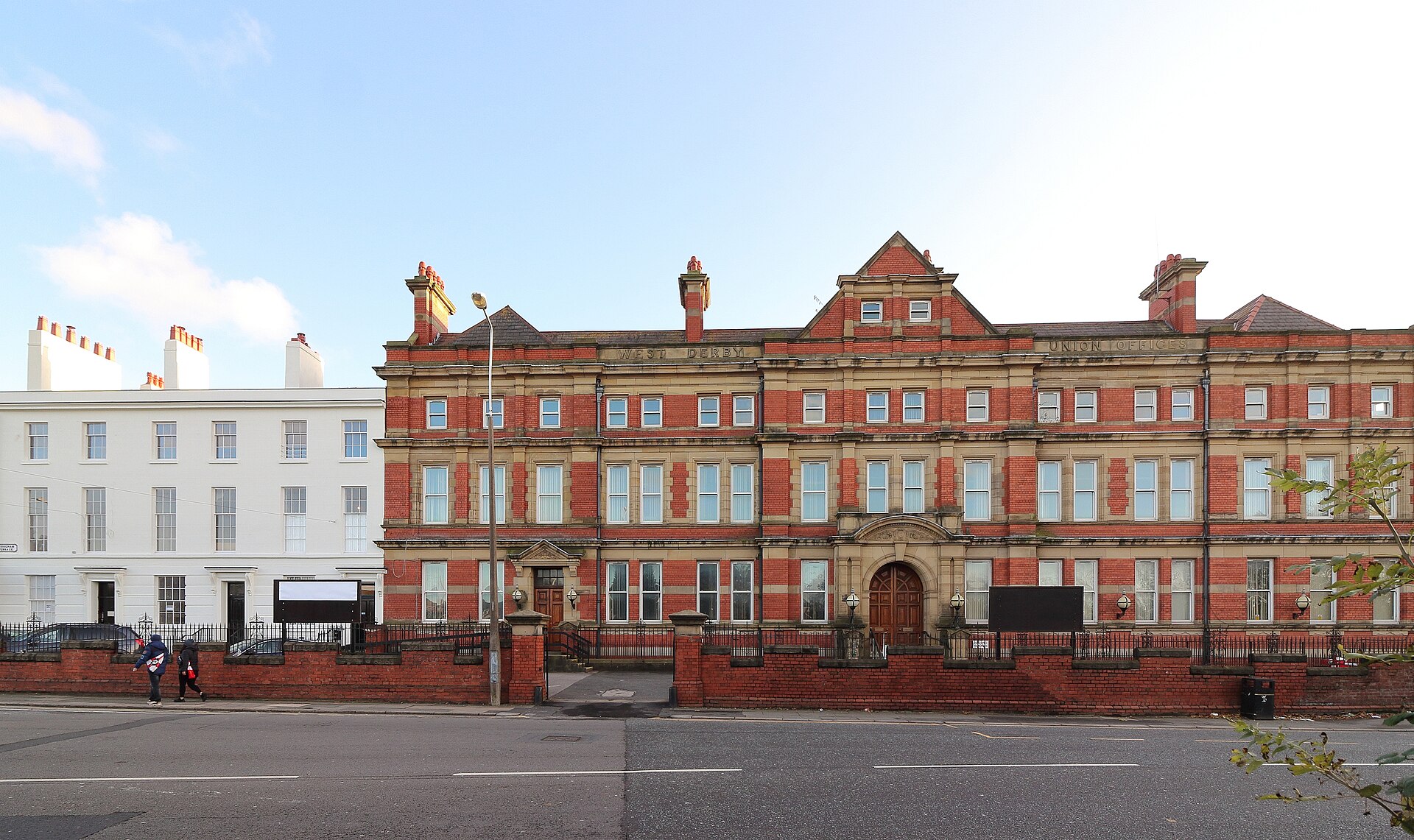 Liverpool for Muslim Travellers: Halal Food, Mosques & Prayer Spaces 1 Brougham Terrace on West Derby Road, Liverpool: a white-painted, restored Georgian terrace with black railings, next to the ornate red-brick former West Derby Union Offices