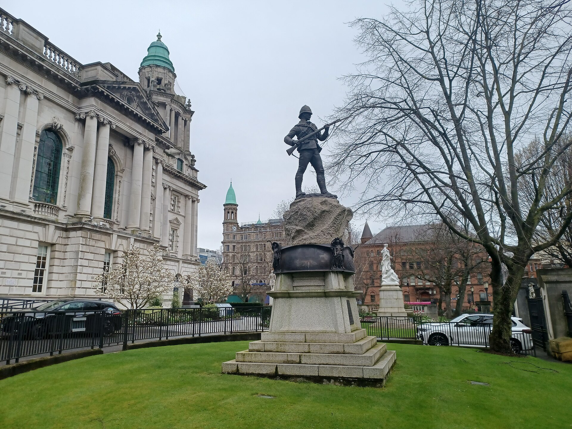 Liverpool to Belfast Ferry & Getting to Ireland from Liverpool 3 The white stone side of Belfast City Hall with its green copper domes, beside a bronze soldier statue on a granite pedestal in the lawned grounds