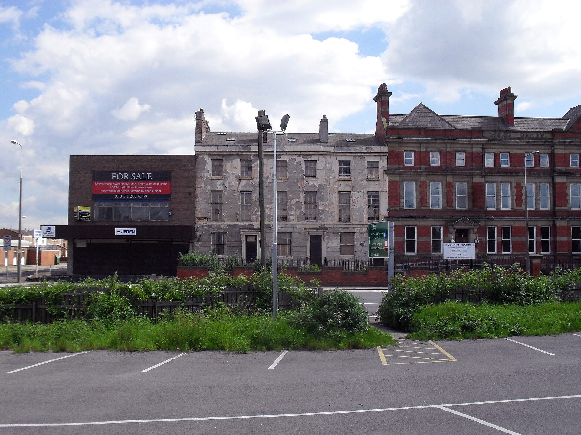 Liverpool for Muslim Travellers: Halal Food, Mosques & Prayer Spaces 2 The same Georgian terrace on Brougham Terrace, Liverpool, in 2012, before restoration: grey, peeling render, boarded windows and a scruffy car park in front