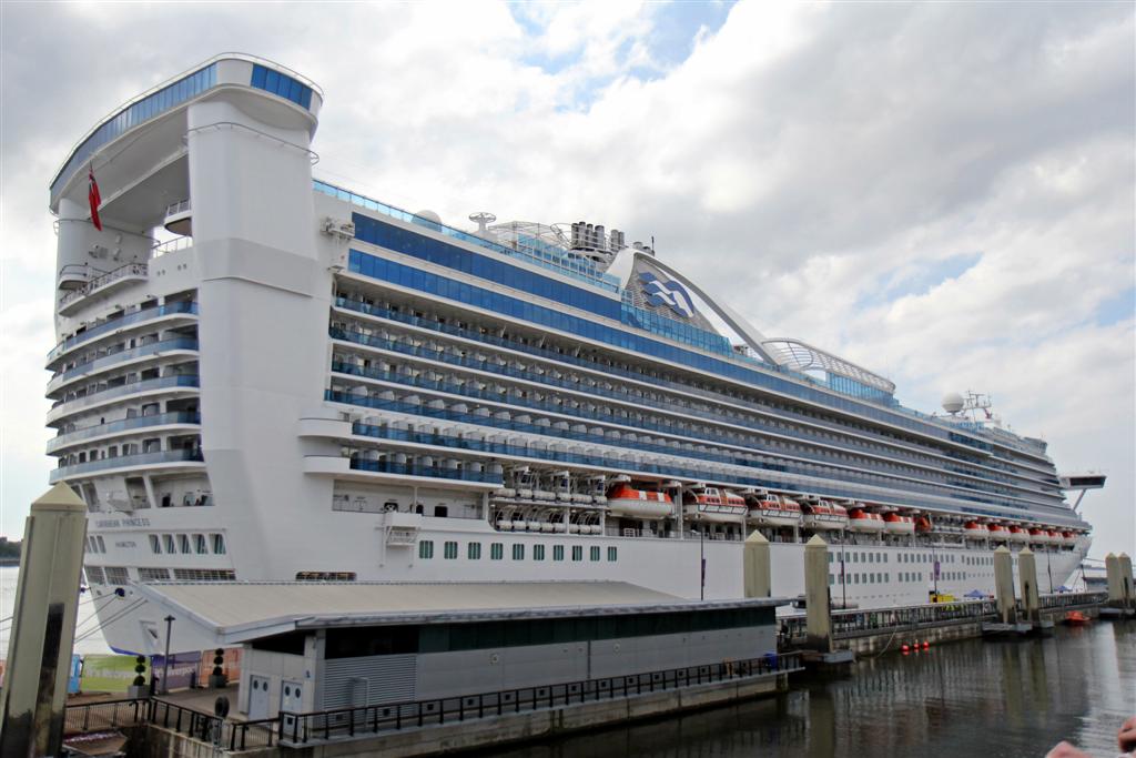 Liverpool Cruise Terminal Guide: Arrivals, Transfers & Facilities 1 The large cruise ship Caribbean Princess moored alongside the low terminal building and covered walkway at Liverpool Cruise Terminal