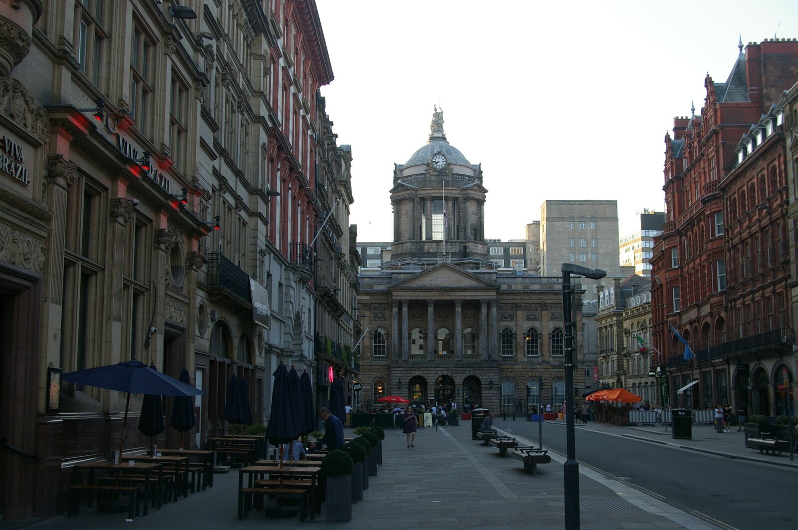 Castle Street in Liverpool lined with ornate Victorian bank buildings and café tables, leading to the domed Liverpool Town Hall