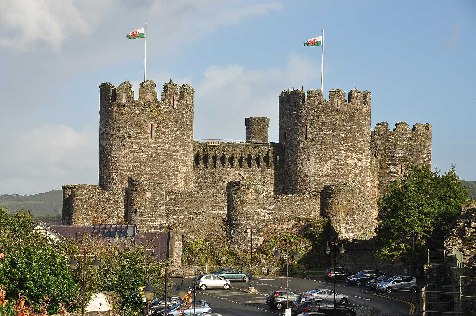 Best Things to Do in Liverpool on a Cruise Stop 3 The massive round towers and battlements of Conwy Castle in North Wales, with Welsh flags flying