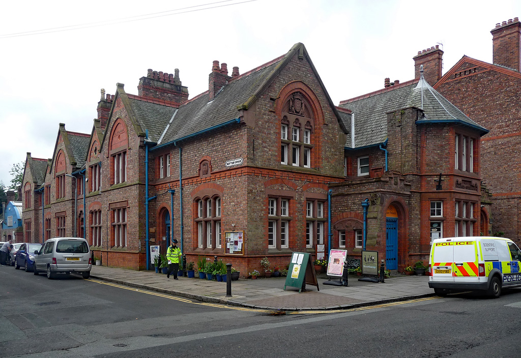 Lark Lane & Aigburth: Liverpool's Bohemian South End 1 The red-brick Victorian former police station on Lark Lane in Liverpool, with gabled roofs, arched windows and blue doors, now a community centre
