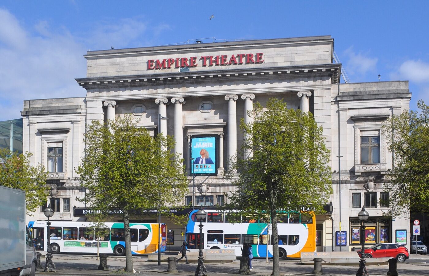 Liverpool Live Entertainment: Arena, Theatres & Comedy Guide 5 The neoclassical stone frontage of the Liverpool Empire Theatre on Lime Street with buses passing in front
