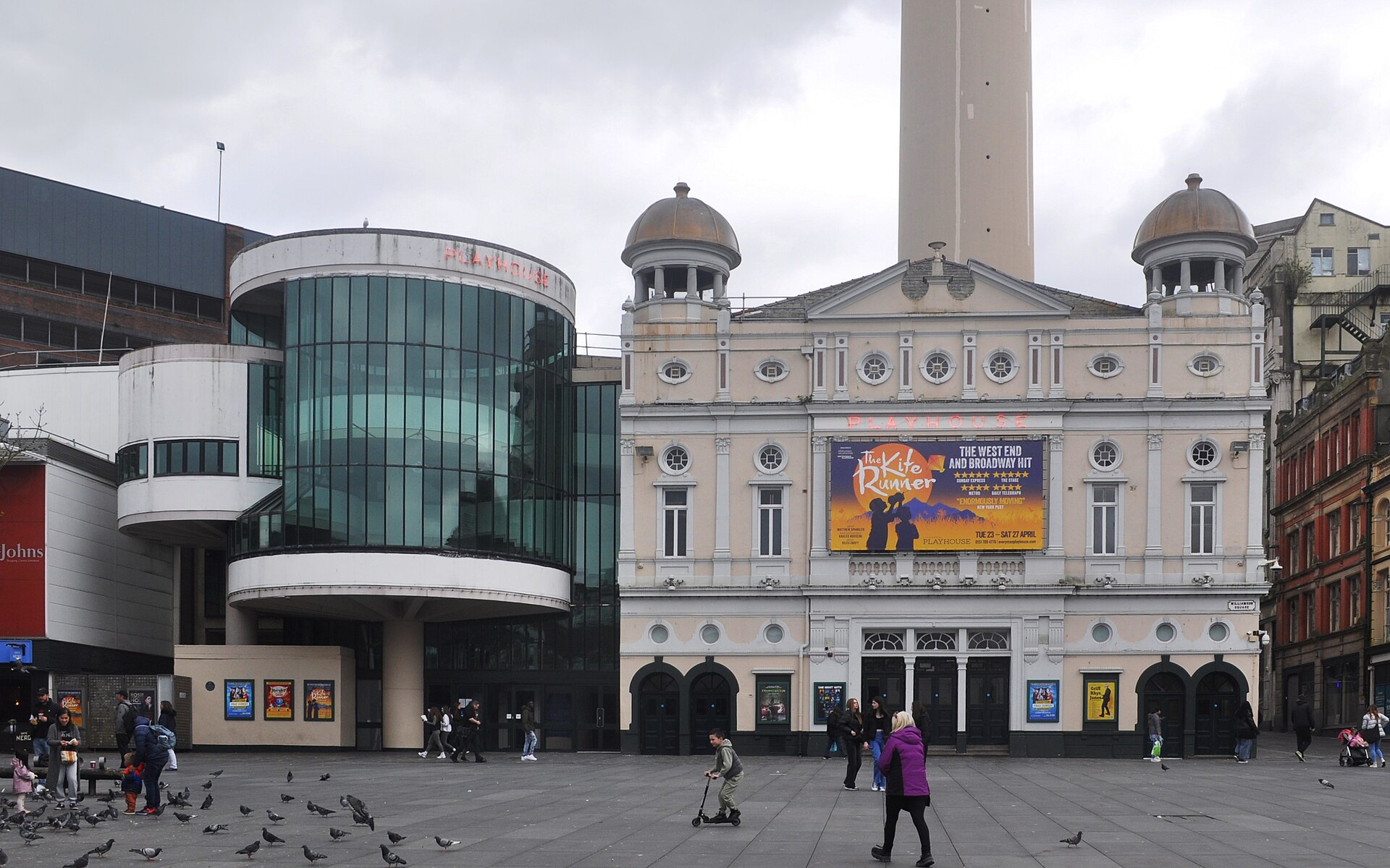 Liverpool Everyman & Playhouse: The City's Producing Theatres 3 The cream Victorian front of the Playhouse Theatre in Williamson Square, Liverpool, with two domed turrets, beside its round glass 1960s foyer extension and St John's Beacon behind