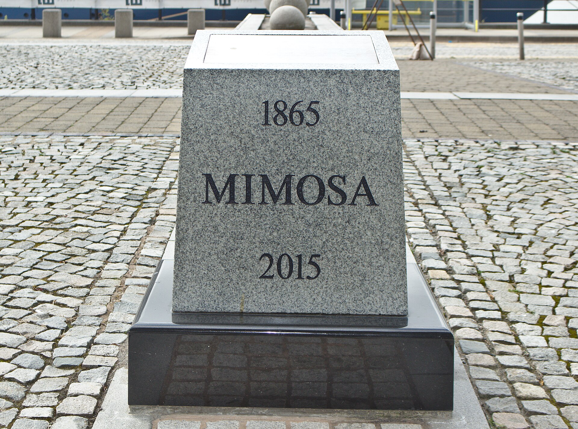 Liverpool Cruise Terminal Guide: Arrivals, Transfers & Facilities 2 A granite memorial block engraved Mimosa 1865 2015 on cobbles at Princes Dock, with a ship's hull in the background