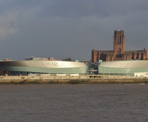 The arena and convention centre complex at Kings Dock in Liverpool seen from the Mersey with the Anglican Cathedral behind