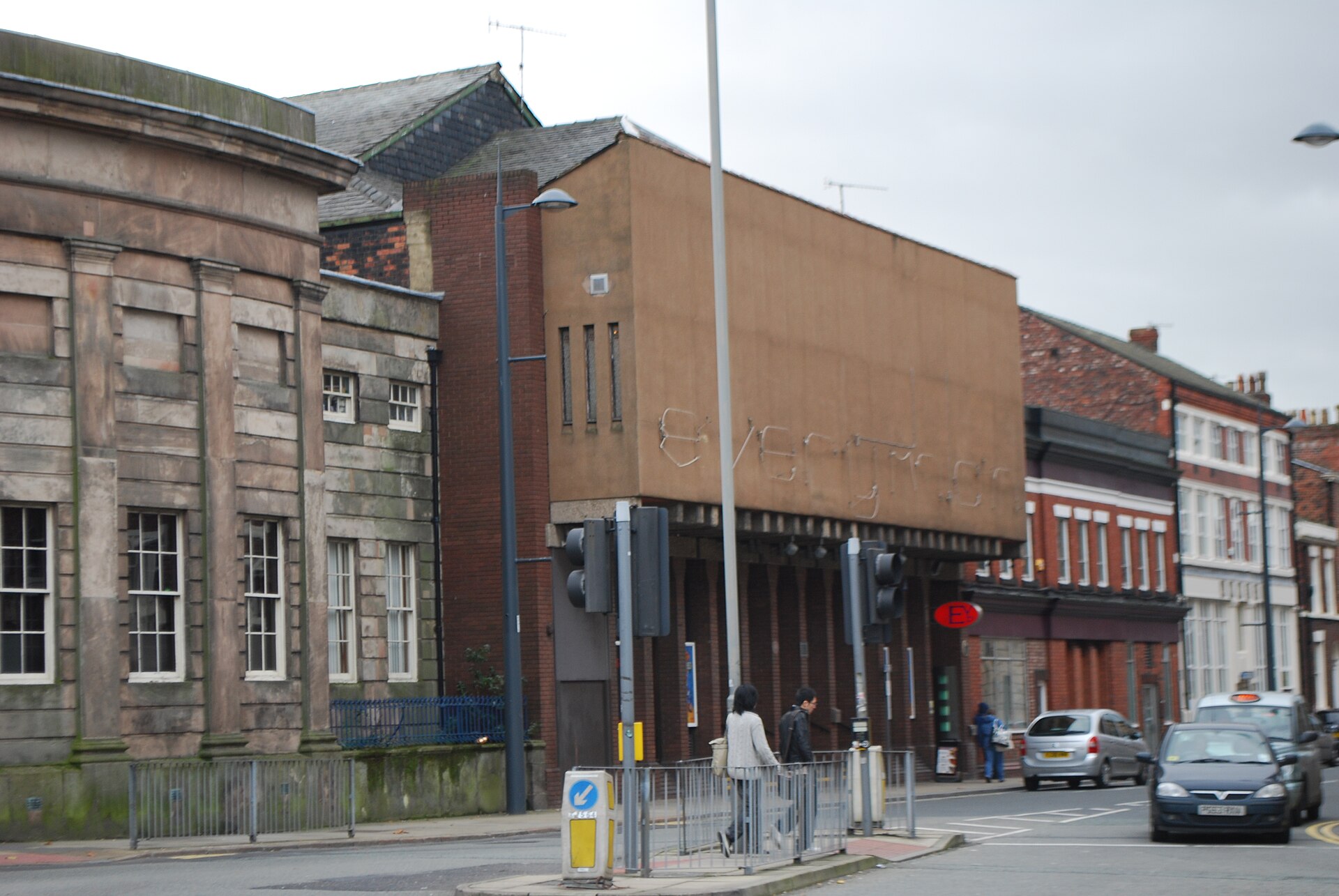 Liverpool Everyman & Playhouse: The City's Producing Theatres 1 The old Everyman Theatre on Hope Street, Liverpool, with a plain brown concrete front, faded lettering and a small red E sign, next to a sandstone building