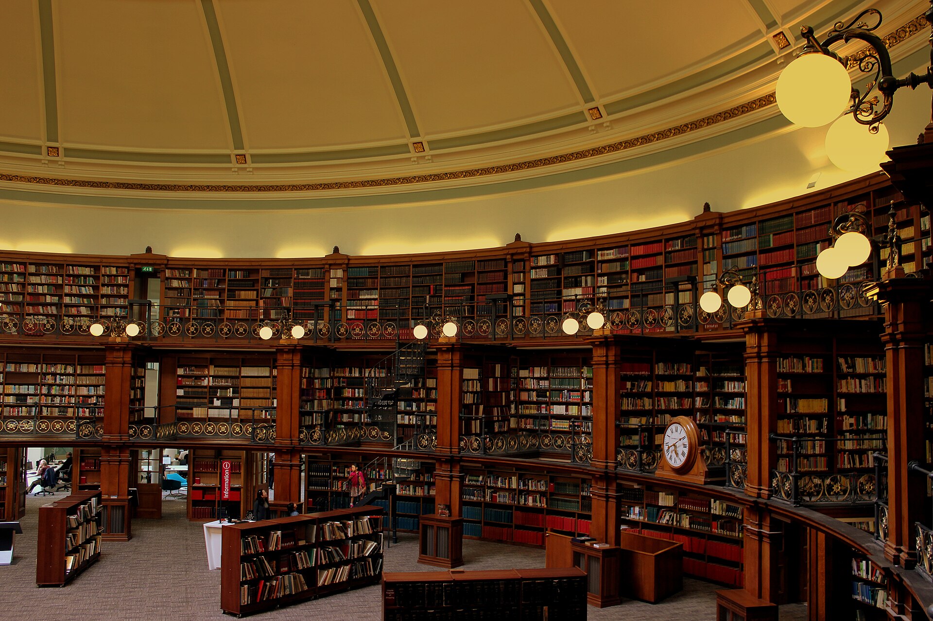 Solo Travel in Liverpool: Safety, Where to Stay & Things to Do Alone 2 The circular domed Picton Reading Room in Liverpool Central Library, with tiers of wooden bookshelves, iron balconies and globe lamps