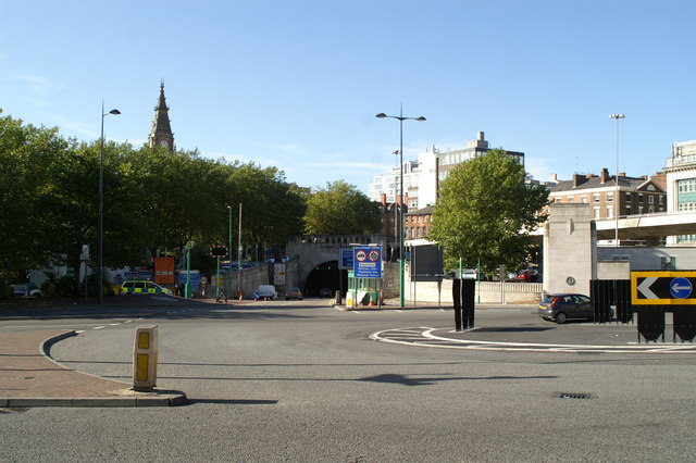 Liverpool on Screen: Blockbusters Filmed in the City 2 The stone portal of the Queensway Tunnel entrance in Liverpool city centre, with the spire of the Liverpool Parish Church behind the trees