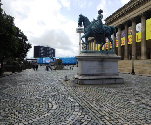 The cobbled forecourt of St George's Hall in Liverpool with its equestrian statue and neoclassical colonnade