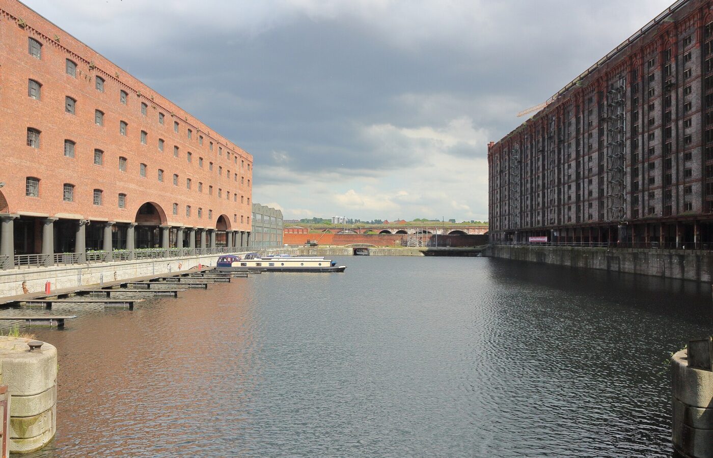 Stanley Dock & the Tobacco Warehouse: Liverpool's Film Backlot 5 Looking along Stanley Dock in Liverpool: the red brick Titanic Hotel warehouse with its cast-iron colonnade on the left, the dark fourteen-storey Tobacco Warehouse on the right and narrowboats moored between