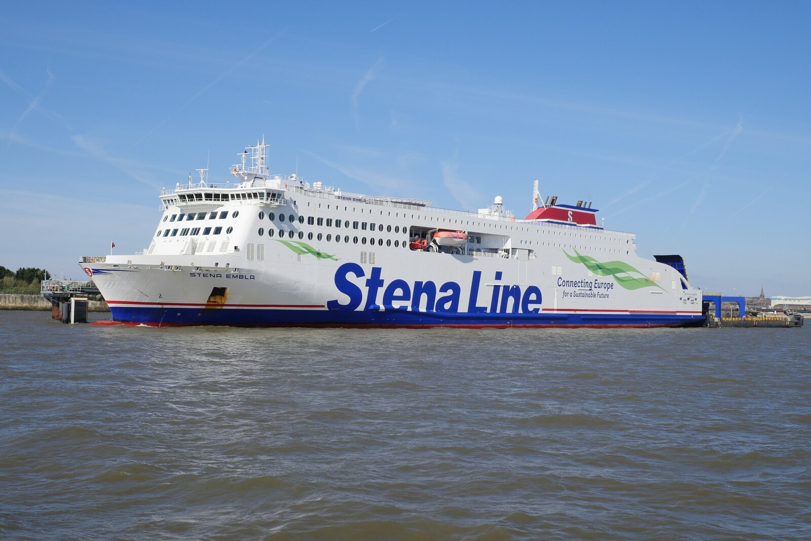 Liverpool to Belfast Ferry & Getting to Ireland from Liverpool 1 The Stena Line ferry Stena Embla, white with a blue hull and large blue lettering, moored at the 12 Quays terminal in Birkenhead on the River Mersey under a blue sky
