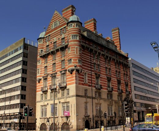 Titanic Liverpool: The City's Connection to the Famous Ship 4 Albion House in Liverpool, with red brick, pale stone bands and tall chimneys above a busy street corner.