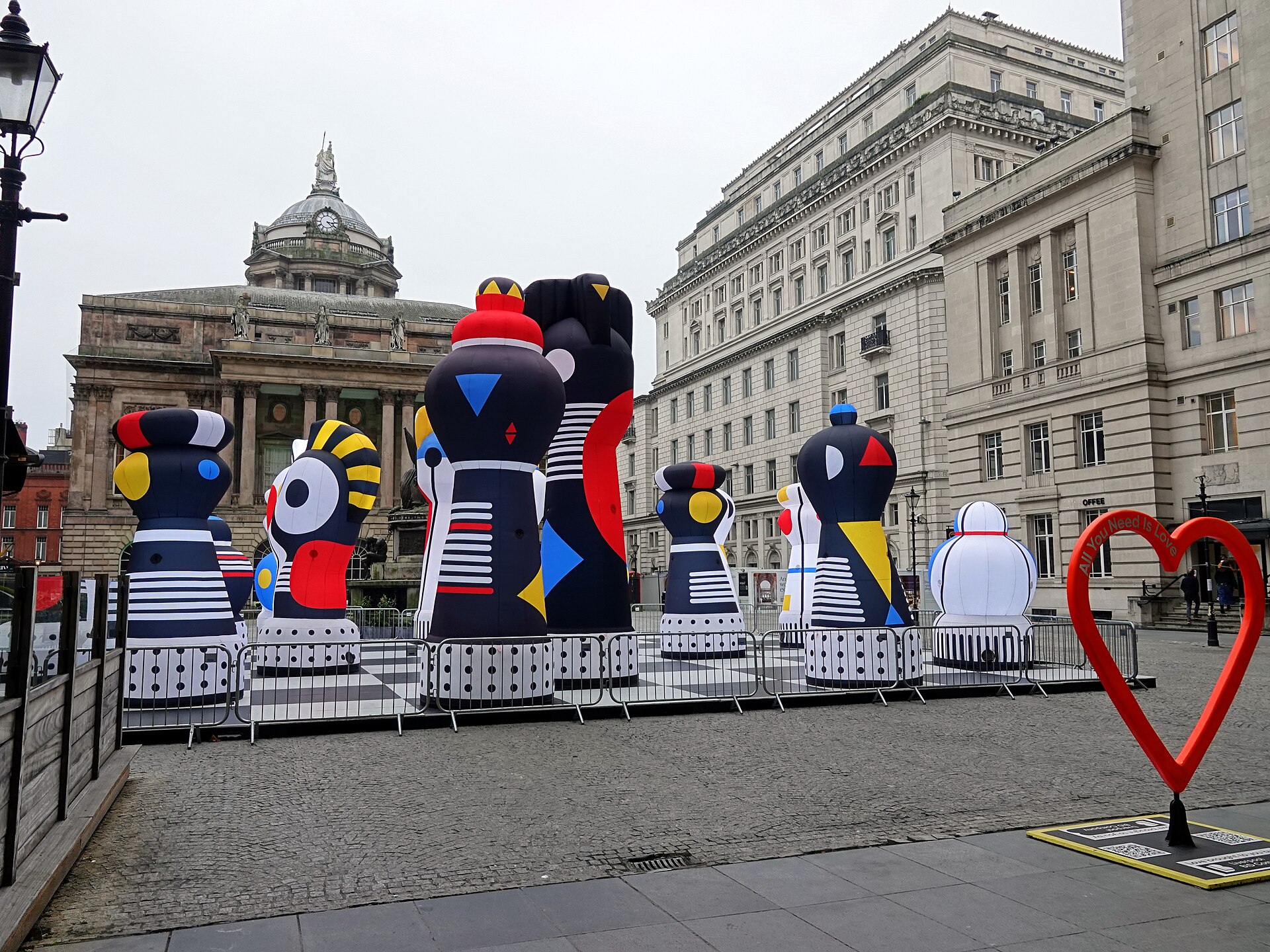 River of Light Liverpool: Winter Illumination Festival Guide 1 Giant inflatable chess pieces of the CHECKMATE installation on Exchange Flags in Liverpool, with the Town Hall dome and stone office buildings behind