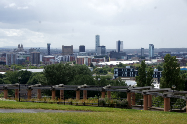 Anfield, Everton & North Liverpool: What's There Beyond the Stadiums 5 The Liverpool city centre skyline seen from the grassy slopes of Everton Brow, with a wooden pergola in the foreground and the Royal Liver Building and towers in the distance