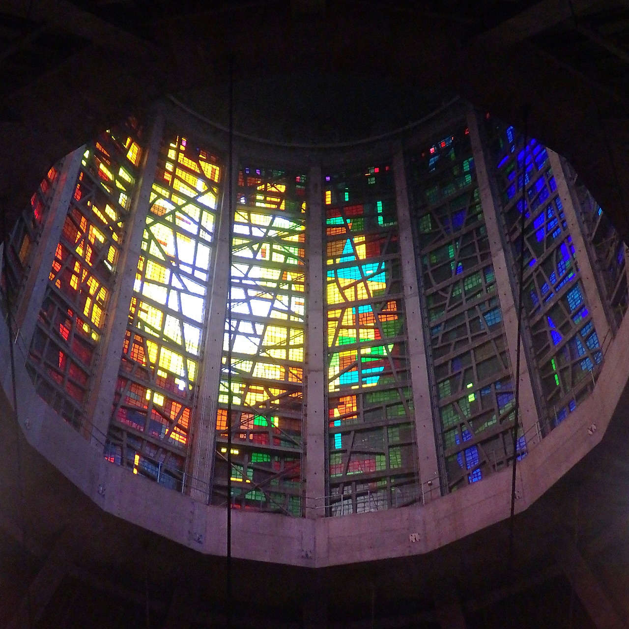 Most Instagrammable Places in Liverpool: Photo Spot Guide 1 Looking straight up into the lantern of Liverpool Metropolitan Cathedral, a ring of tall stained-glass panels in reds, yellows, greens and blues set in a concrete frame