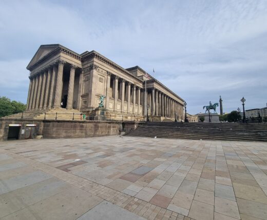 St George's Hall Liverpool: Architecture & History Guide 2 St George's Hall in Liverpool, with its columned portico and long facade above broad steps and a paved square.